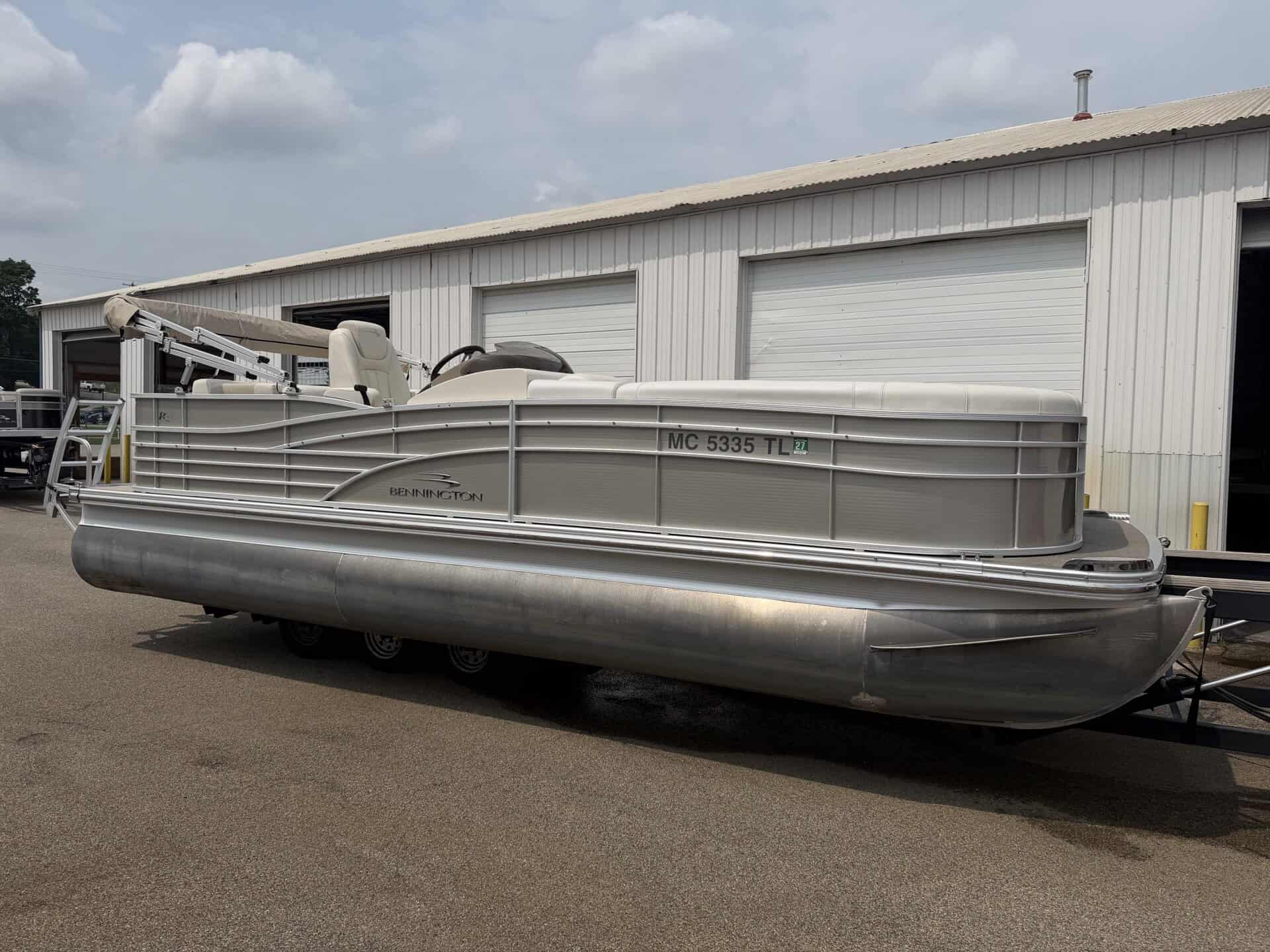 Bennington 2275 RL pontoon boat parked outside Hall's Sport Center.
