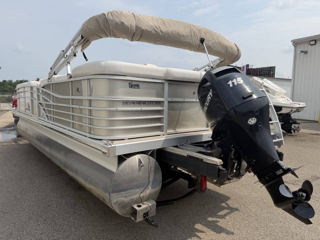 Bennington 2275 RL pontoon boat with outboard motor and canopy.
