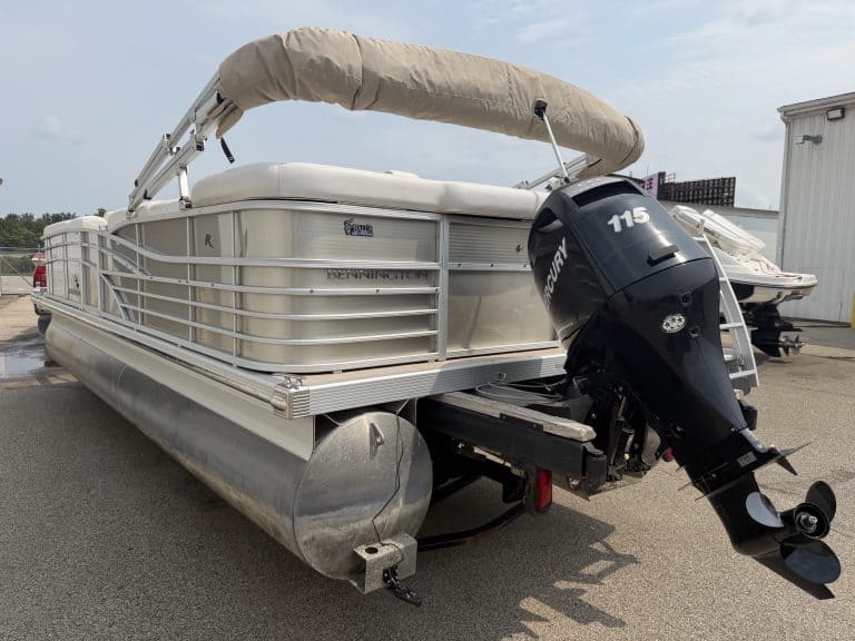 Bennington 2275 RL pontoon boat with outboard motor and canopy.