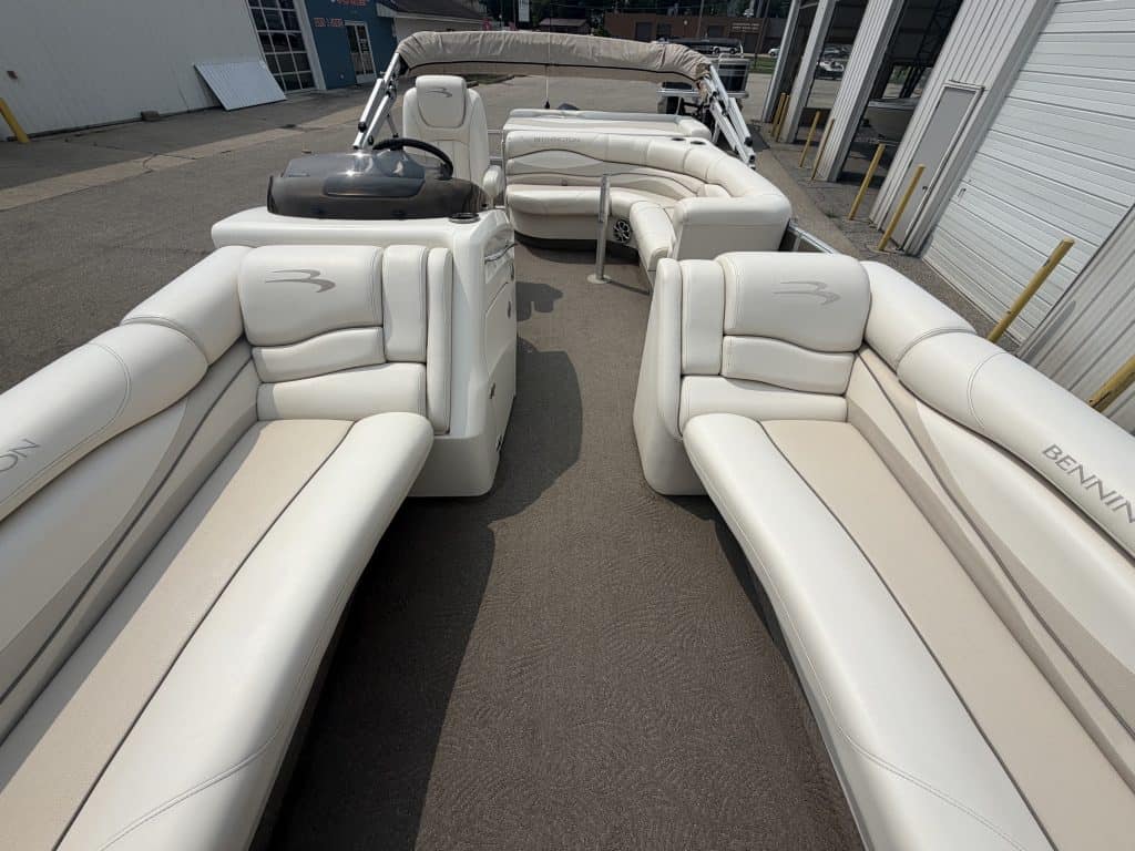 Luxury white pontoon boat with seating for multiple passengers.