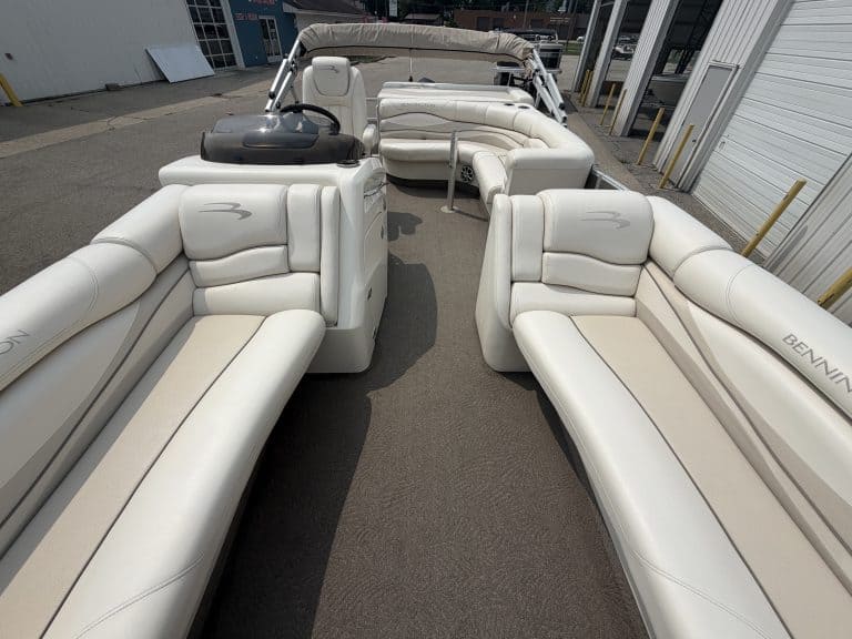 Luxury white pontoon boat with seating for multiple passengers.