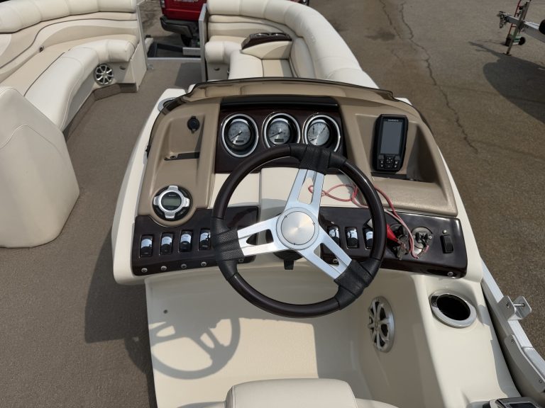 Boat dashboard with steering wheel and gauges for Bennington 2275 RL.