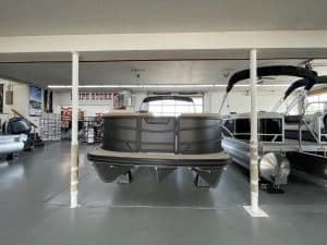 Luxury pontoon boat displayed at Hall's Sport Center showroom.