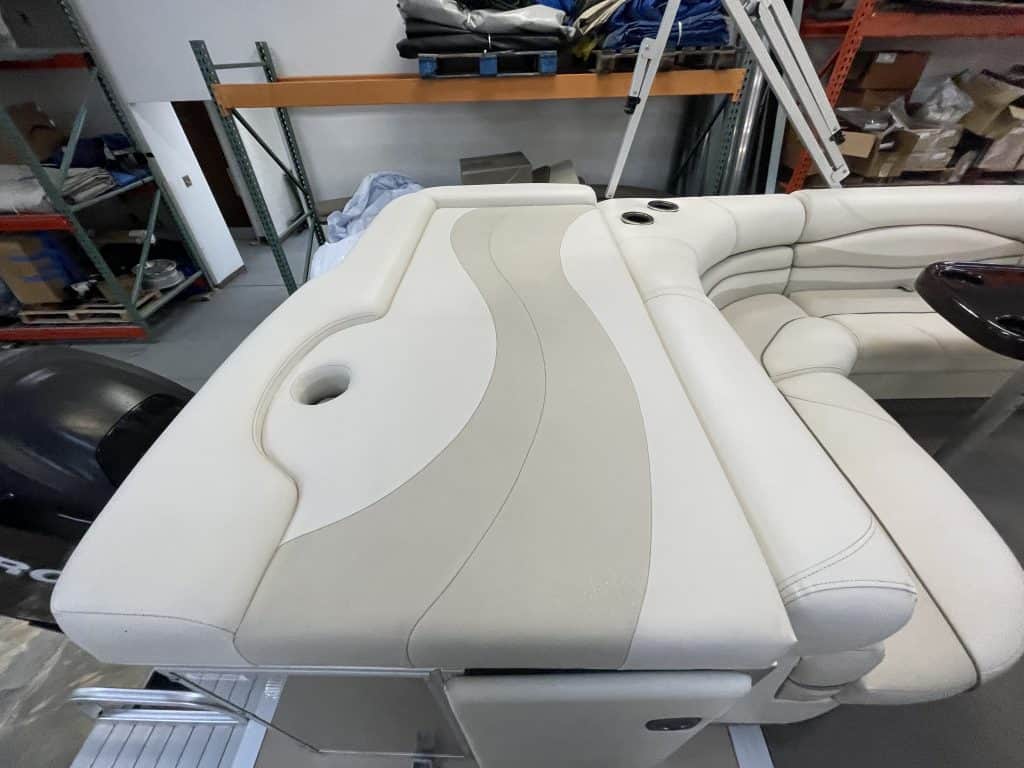 Luxury boat seating with beige and white upholstery at Hall's Sport Center.