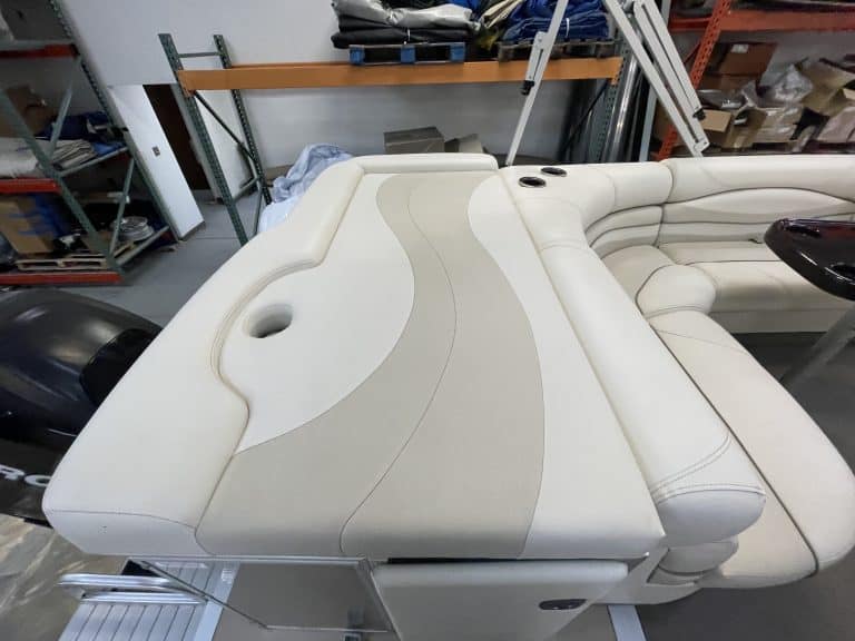 Luxury boat seating with beige and white upholstery at Hall's Sport Center.