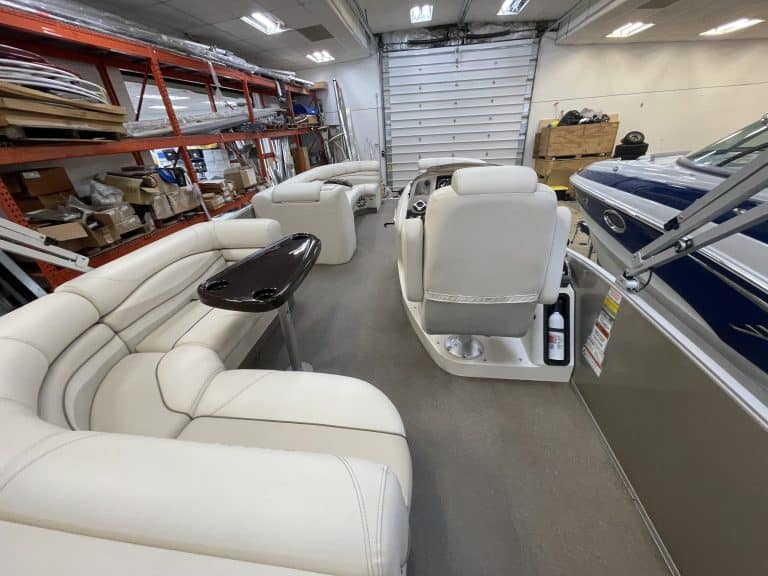 Interior view of a Bennington 2275 RL pontoon boat with white seating.