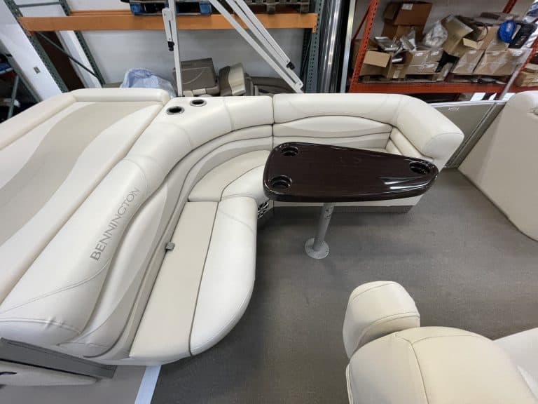 Bennington 2275 RL boat seating with built-in cooler and table.
