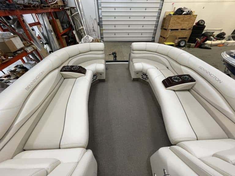 White boat seating with cup holders in a garage setting.