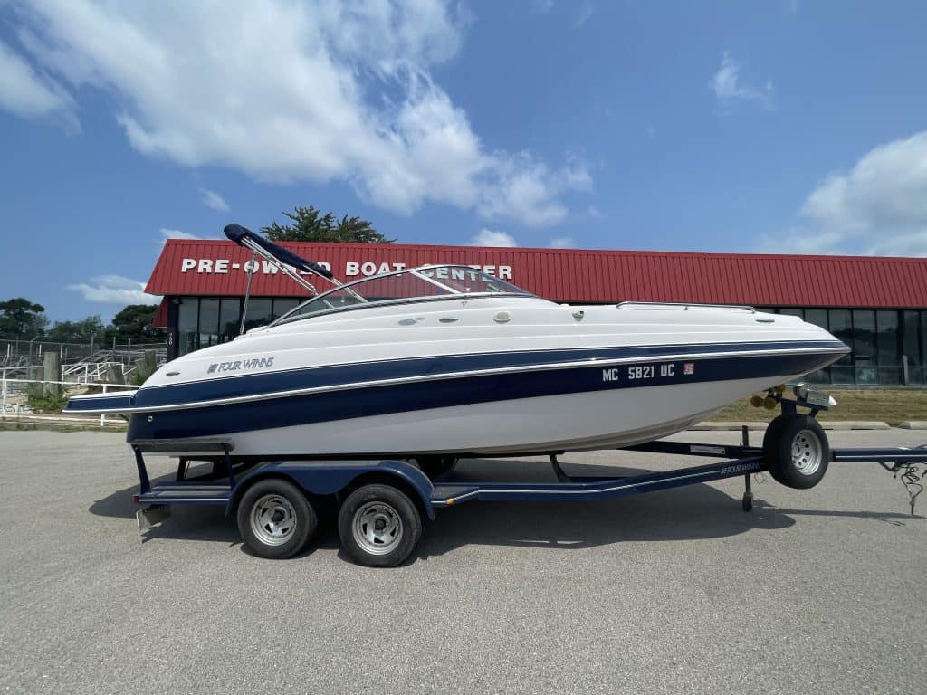 Four Winns 224 Funship speedboat on trailer at Hall's Sport Center.