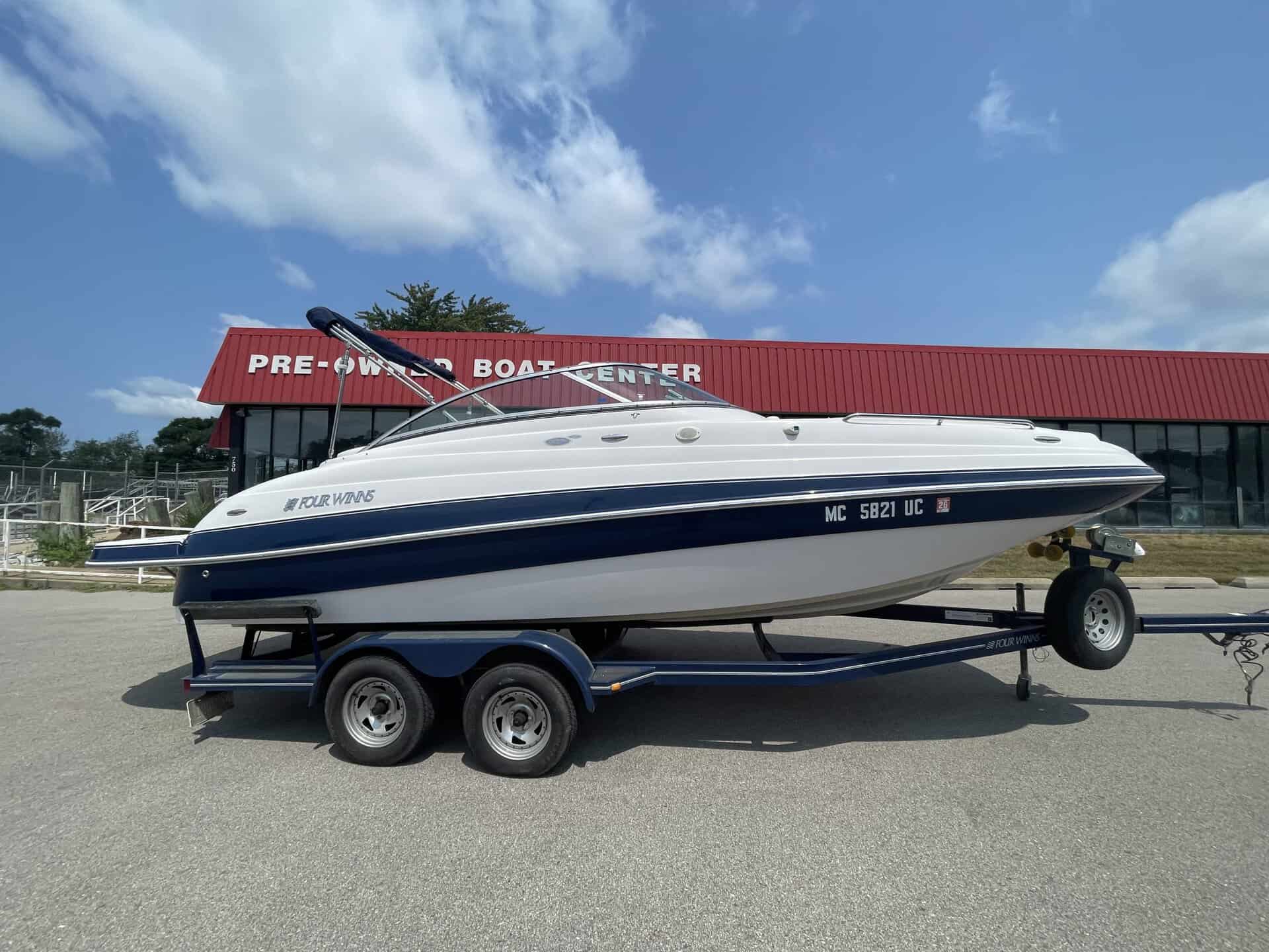 Four Winns 224 Funship speedboat on trailer at Hall's Sport Center.