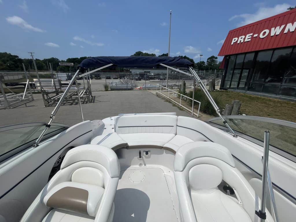Luxury boat with white seating and blue canopy at Hall's Sport Center.