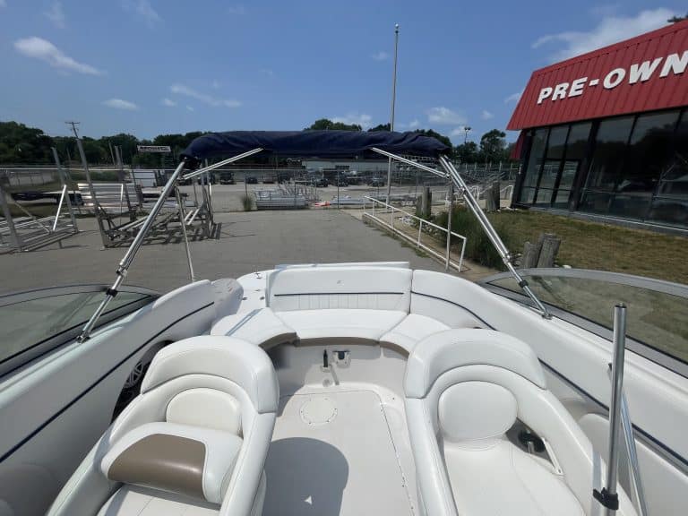 Luxury boat with white seating and blue canopy at Hall's Sport Center.