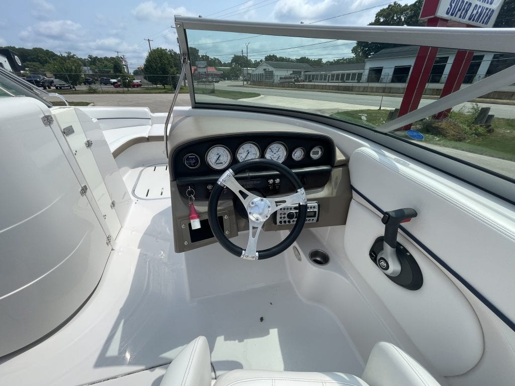 Boat dashboard and steering wheel of a 2007 Four Winns 224 Funship.