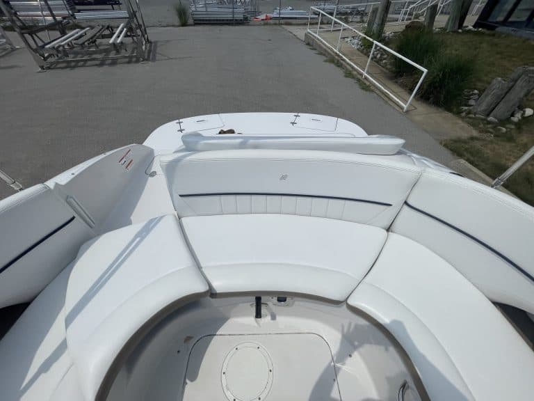 White Four Winns 224 FUNSHIP boat docked at marina.