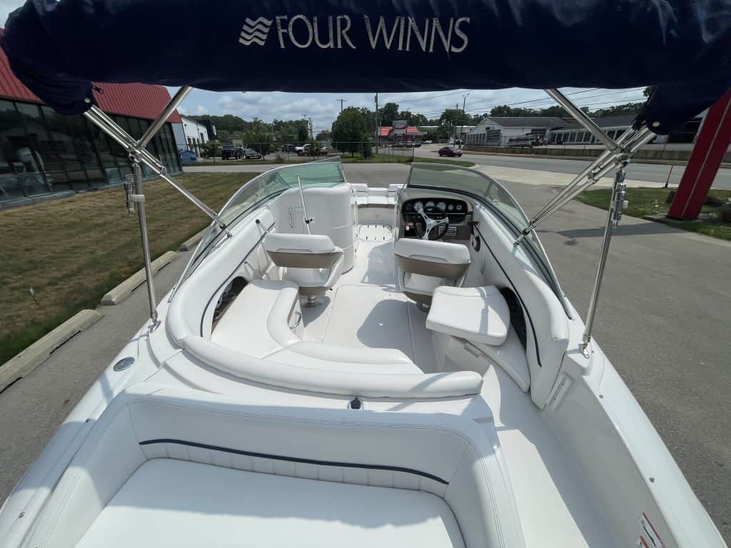 Interior view of a Four Winns 224 Funship boat with seating and steering wheel.
