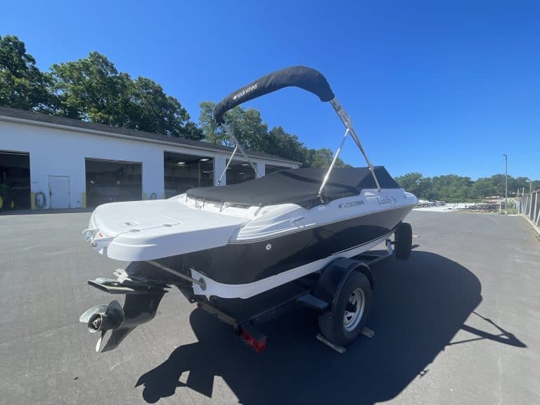 White and black 2011 Four Winns 180H boat on trailer at Hall's Sport Center.