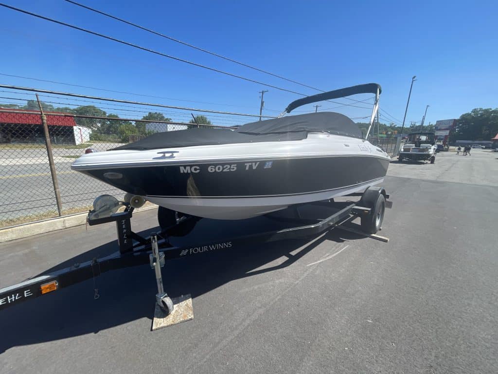 Four Winns 180H speedboat on trailer at Hall's Sport Center.