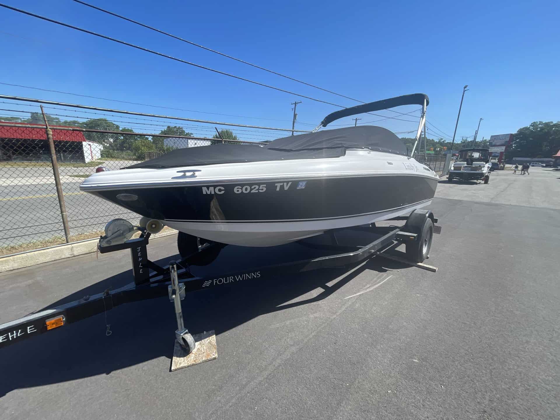Four Winns 180H speedboat on trailer at Hall's Sport Center.