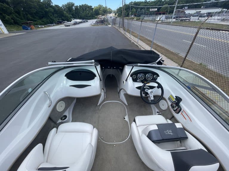 Interior view of a 2011 Four Winns 180H boat with steering wheel and seating.