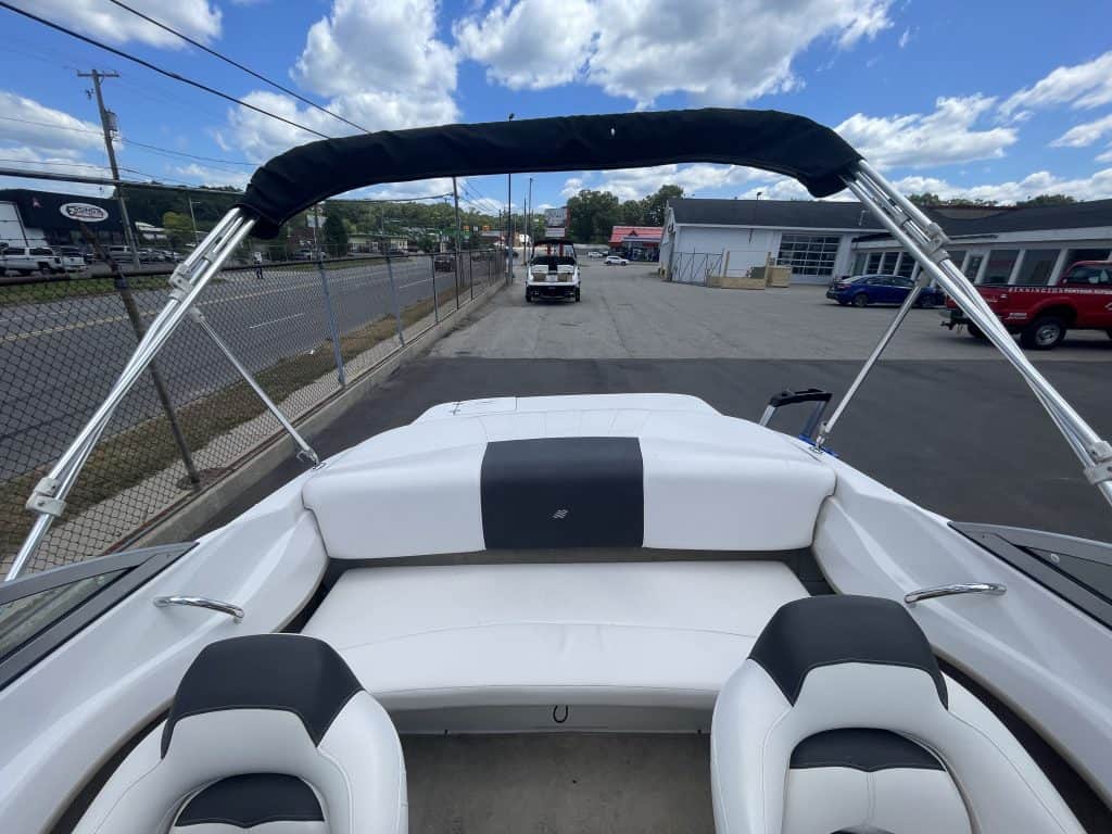 White Four Winns 180H boat with black canopy at Hall's Sport Center.