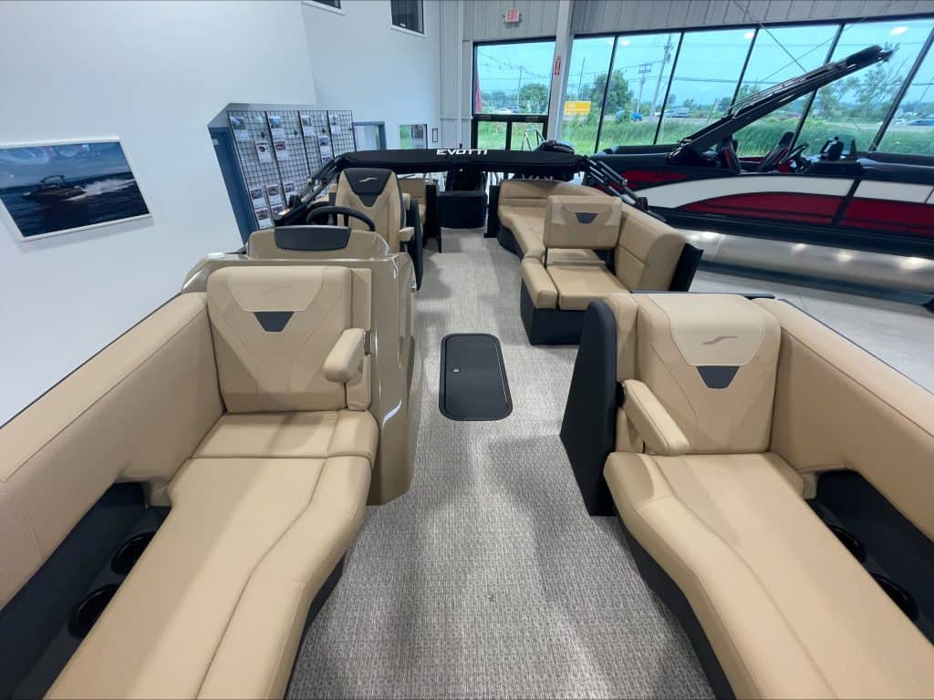 Luxury boat interior with beige seating and large windows at Hall's Sport Center.