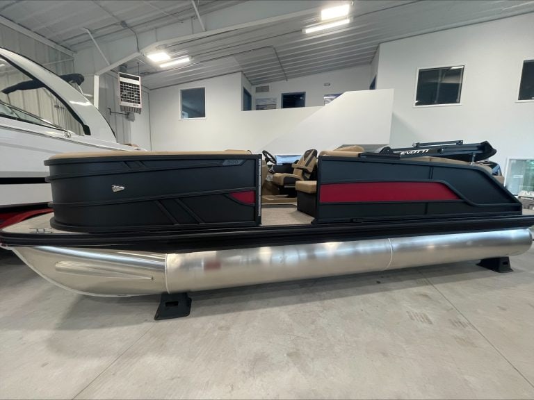 Luxury pontoon boat at Hall's Sport Center with seating and sleek design.