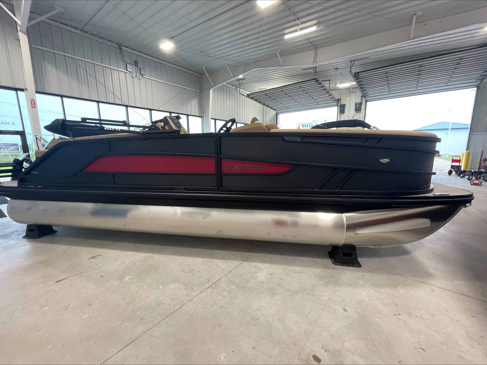 Luxury pontoon boat at Hall's Sport Center with sleek design and modern features.