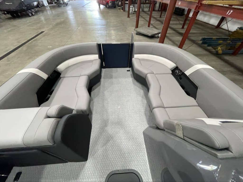 Pontoon boat with gray and white seating at Hall's Sport Center.