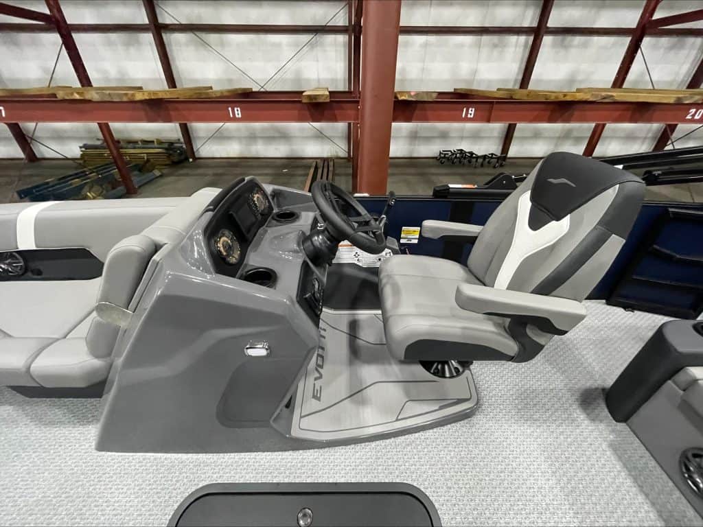 Boat helm with steering wheel and control panel at Hall's Sport Center.