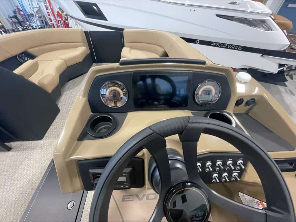 Luxury boat dashboard with steering wheel and controls at Hall's Sport Center.