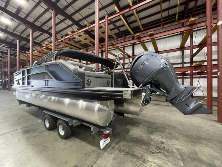 Pontoon boat with Yamaha engine inside a warehouse at Hall's Sport Center.
