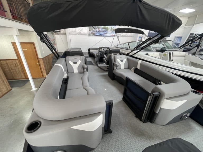 Luxury pontoon boat with seating and steering console at Hall's Sport Center.