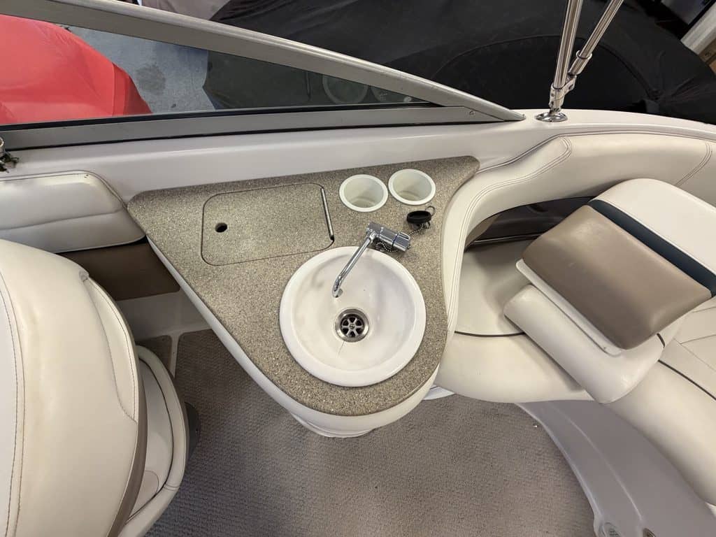 Close-up of boat dashboard and sink in a 2005 Four Winns 230.