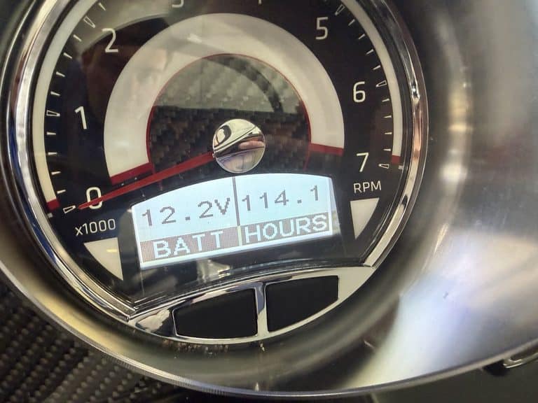 Close-up of boat instrument panel showing RPM and hours.