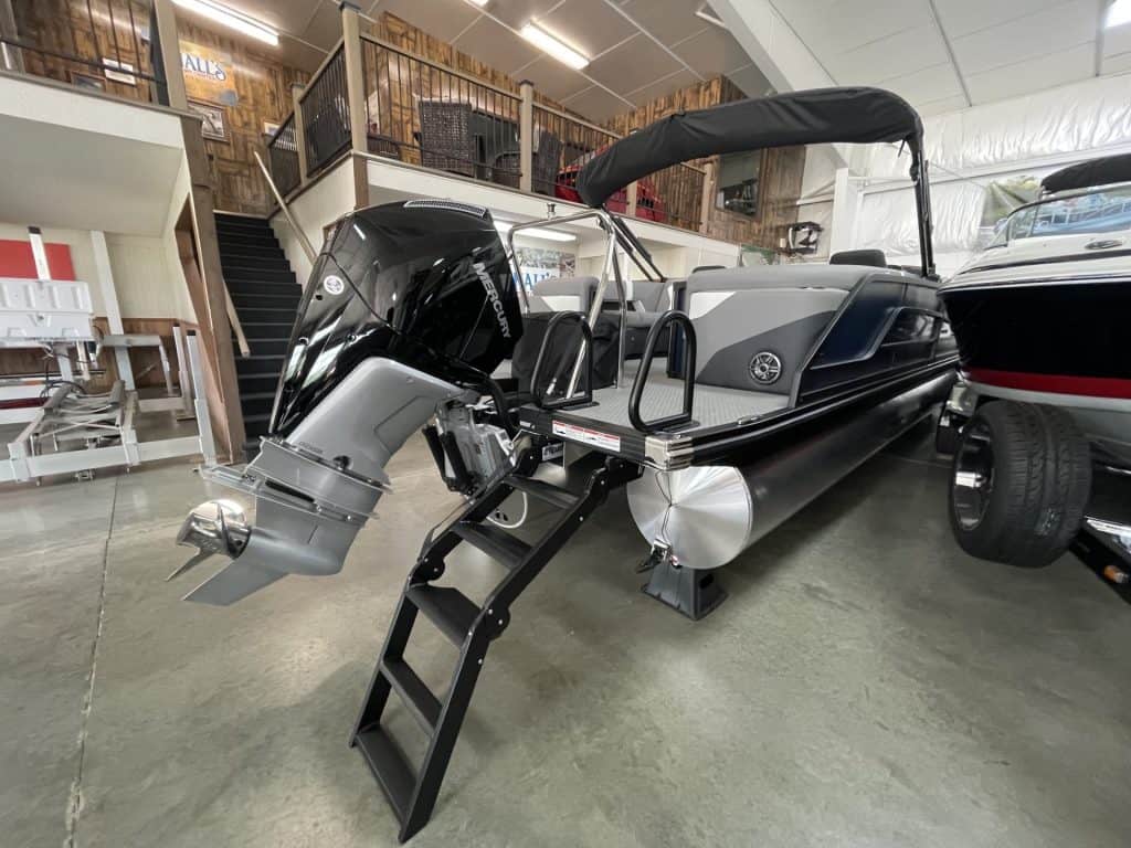 Luxury boat with outboard motor and canopy at Hall's Sport Center.
