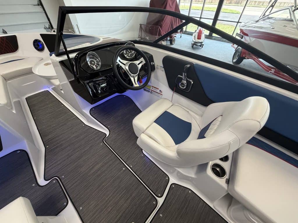 Interior view of a Glastron GX215 boat with steering wheel and seating.