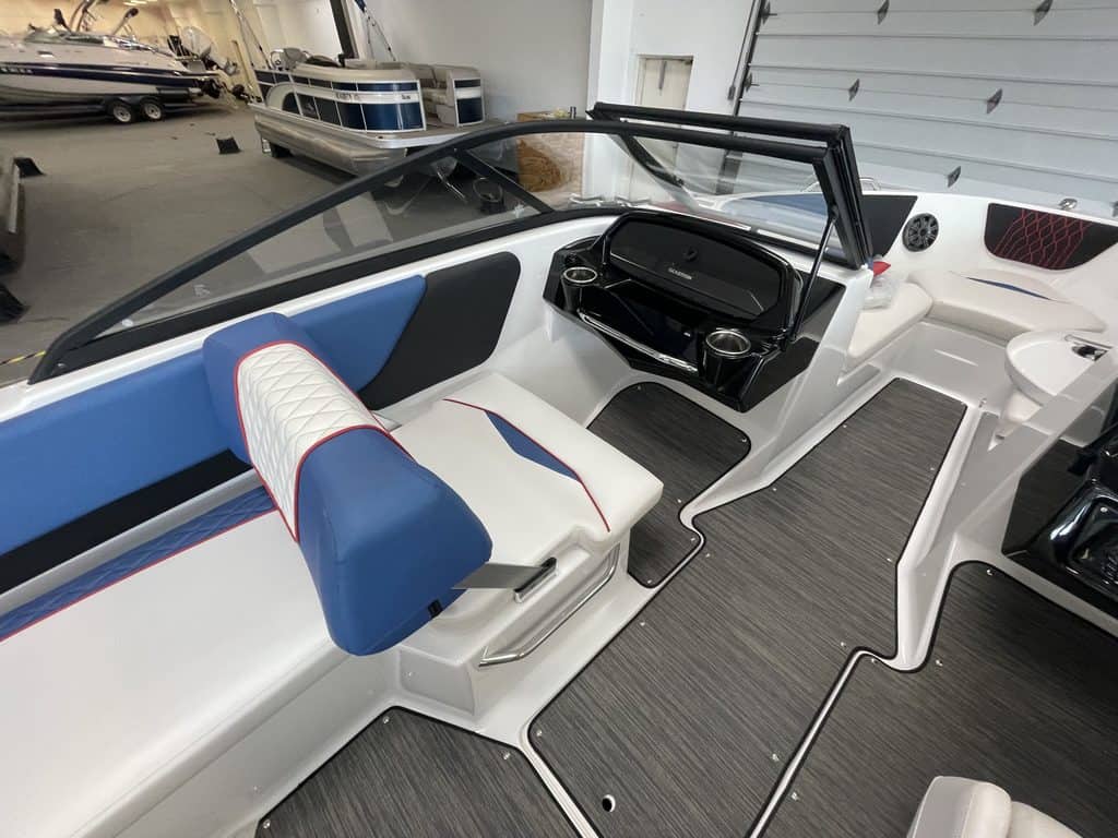 Interior view of a Glastron GX215 boat with seating and dashboard.