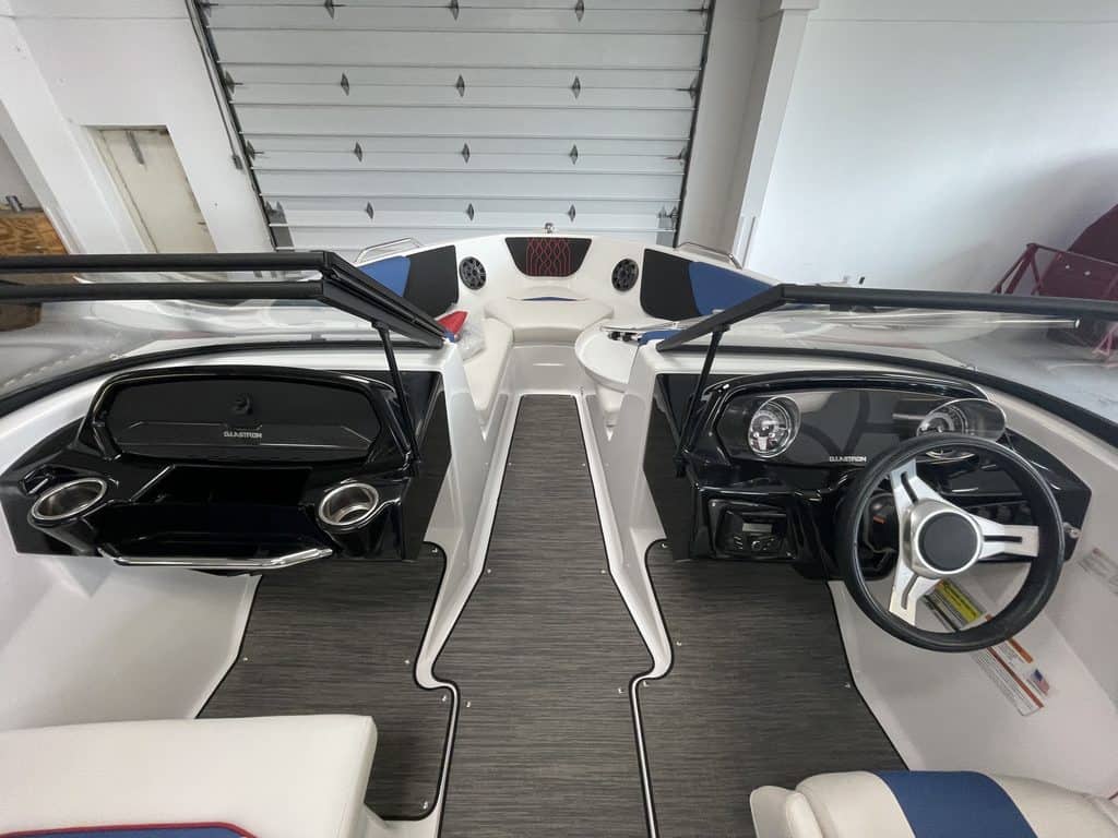 Interior view of a Glastron GX215 boat with steering wheel and dashboard.