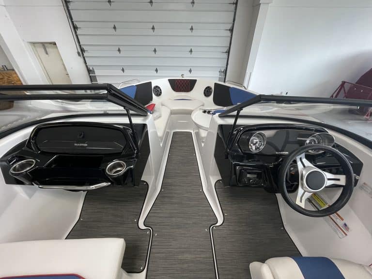 Interior view of a Glastron GX215 boat with steering wheel and dashboard.