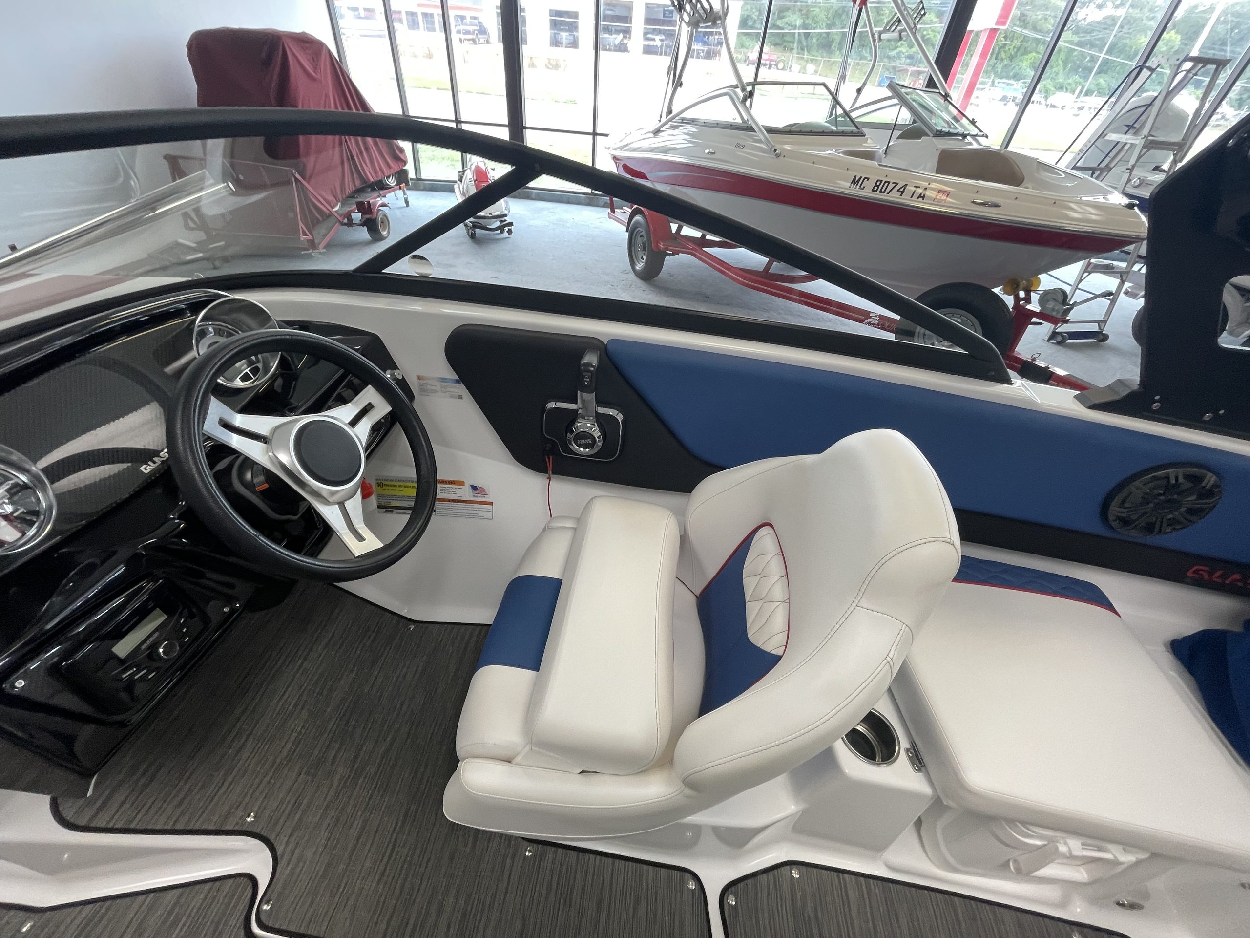 Close-up of the cockpit and seating area of a Glastron GX215 boat.