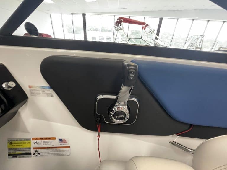 Close-up of boat dashboard with steering and controls at Hall's Sport Center.