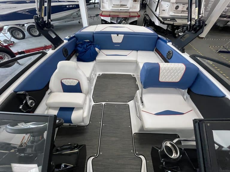 Interior view of a Glastron GX215 boat with seating and steering area.