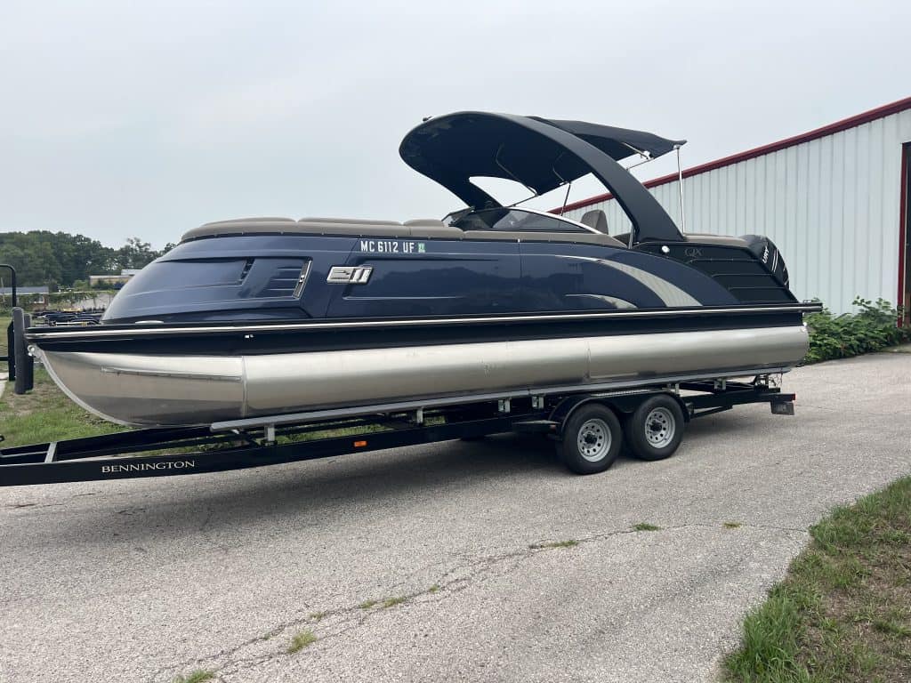 Luxury Bennington pontoon boat on trailer at Hall's Sport Center.