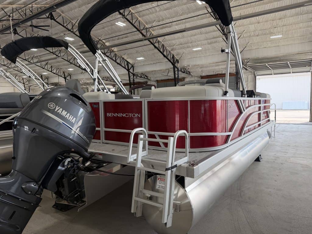 Bennington pontoon boat with Yamaha engine inside Hall's Sport Center.
