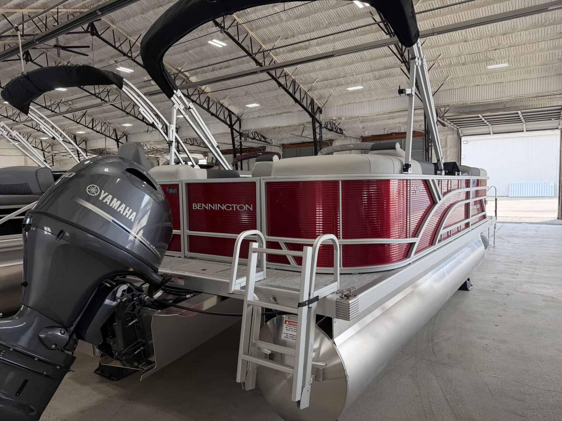 Bennington pontoon boat with Yamaha engine inside Hall's Sport Center.