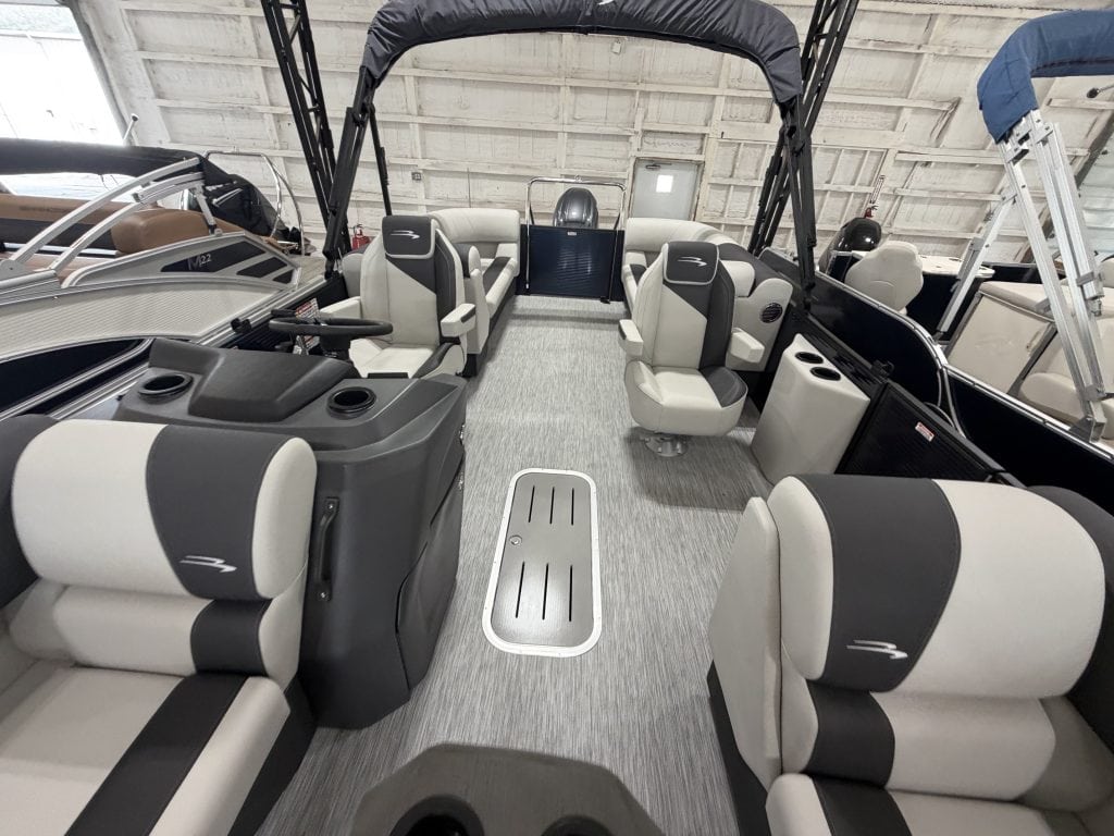 Interior view of a Bennington 22 S1SR pontoon boat with seating and steering area.