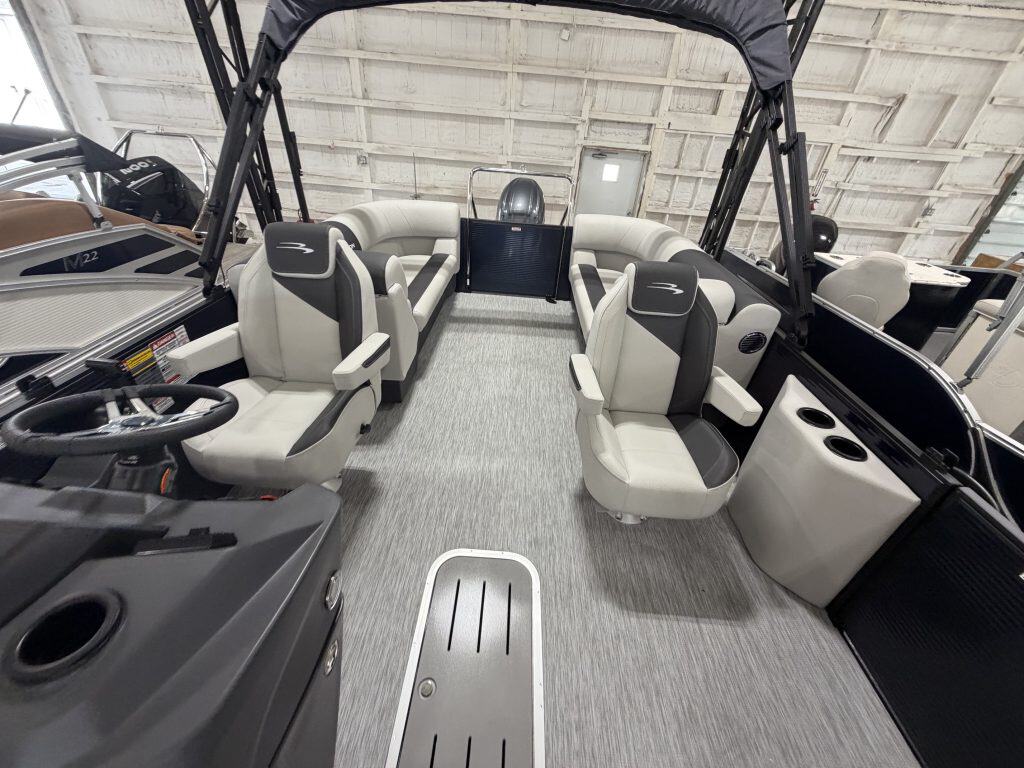 Interior view of a Bennington 22 S1SR pontoon boat with seating and steering area.