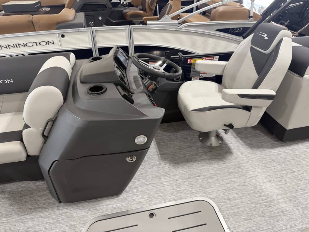 Bennington 22 S1SR pontoon boat cockpit with steering and seating.