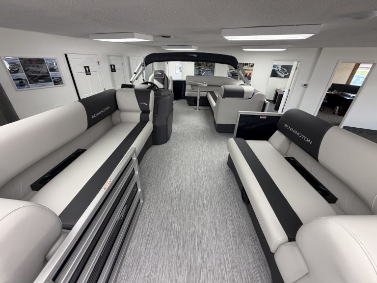 Luxury boat interior with seating and steering console at Hall's Sport Center.