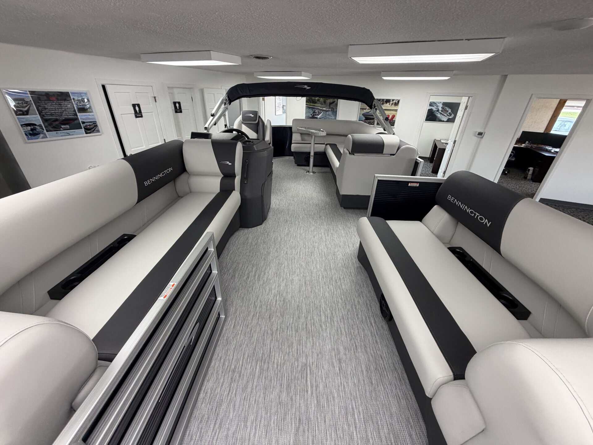 Luxury boat interior with seating and steering console at Hall's Sport Center.